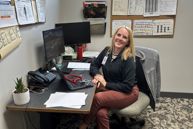 employee smiling at desk