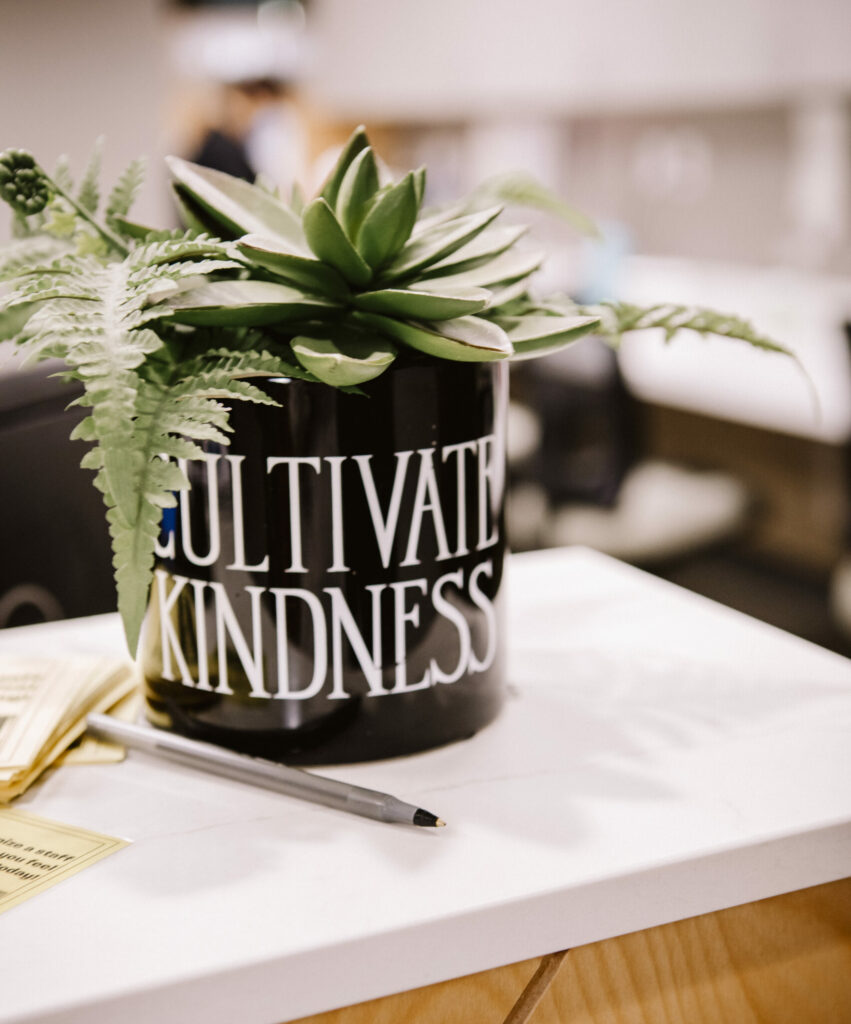 Potted plant labeled cultivate kindness